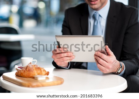 Corporate manager checking mails on his tablet device
