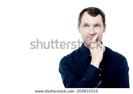 Thoughtful businessman with finger on lips