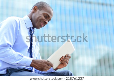 Male executive looking digital tablet at outdoors