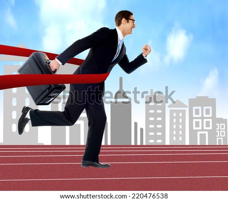 Businessman running on track, cityscape background