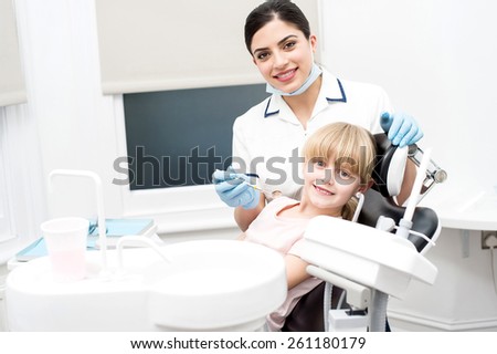 Girl child and dental hygienist at dental clinic