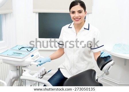 Female dental assistant with welcome smile