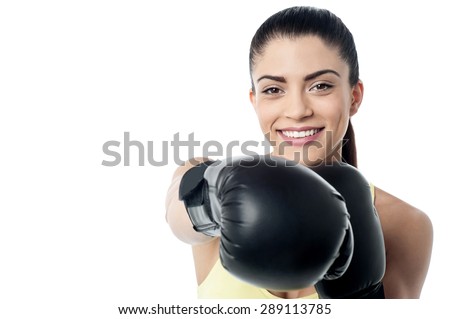 Fit woman ready to fight with boxing gloves