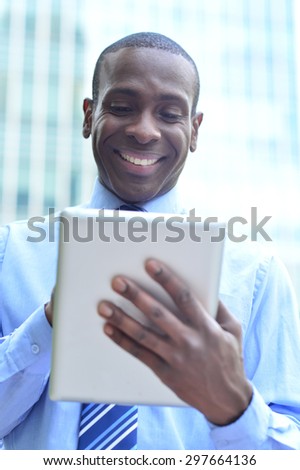 Smiling male executive working in his digital tablet
