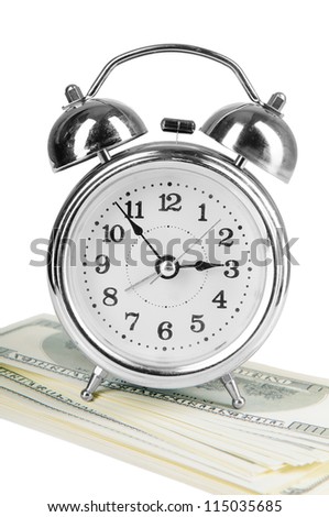 old style alarm clock and a lot of dollars.  isolated on white