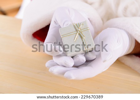 Santa Claus with gift box. gives a gift