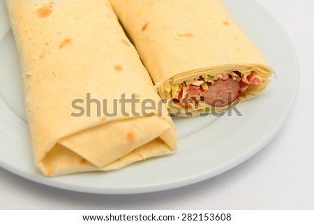 pita bread roll with sausage and salad