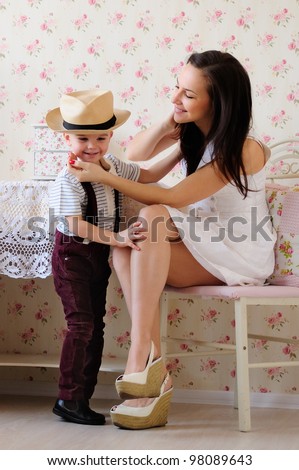 young mother and little son, a friendly talk. bright room, the interior