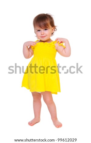 Pretty girl posing for the camera, in a yellow short dress. isolated on white