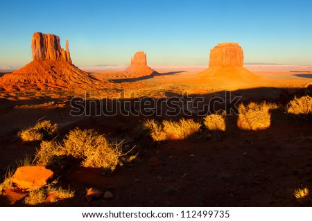 The Mittens of Monument Valley with shadows lengthening in the setting sun