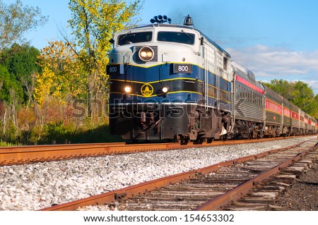 BRECKSVILLE, OH - SEPTEMBER 14: A passenger train on the Cuyahoga Valley Scenic Railroad passes through Brecksville Ohio on September 14 2013. The CVSR makes popular runs from near Cleveland to Akron.