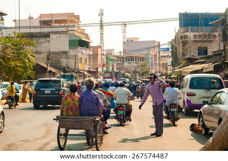 PHNOM PENH, CAMBODIA - FEBRUARY 28, 2014: Congested traffic of all types makes slow progress along National Highway 1 in the southeast section of the Cambodian capital.