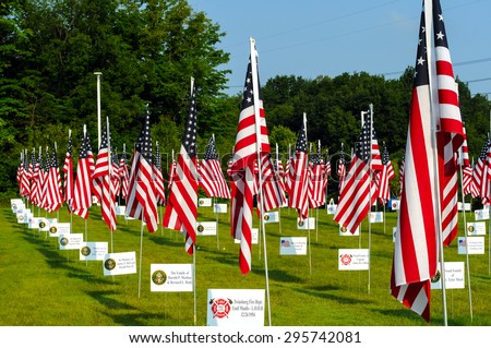TWINSBURG, OH, USA - JULY 4, 2015: A field of flags honors veterans and fallen soldiers as part the Cost of Freedom tribute, a traveling veterans-based exhibit honoring those who served their country
