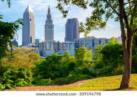 Downtown Cleveland, Ohio, in morning light framed by trees in a small park