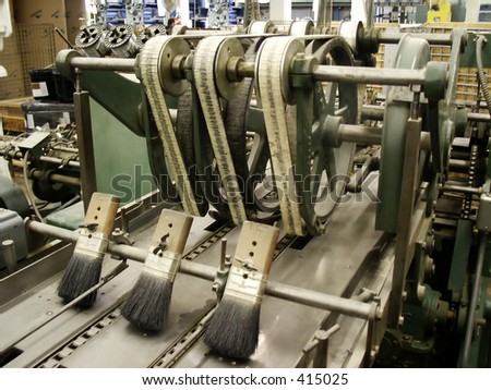 Brushes and belts on old (long idled) stitching machine in publishing house