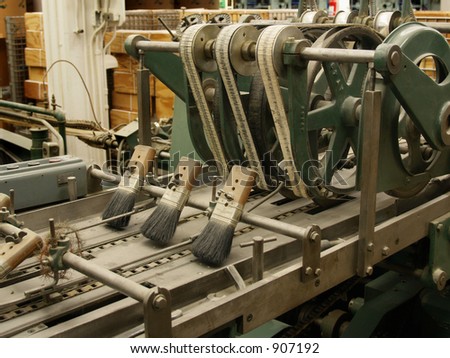 Belts and brushes on ancient stitching machine in publishing house