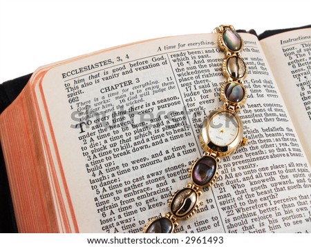 Bible open to Ecclesiastes 3 (a time for every thing) with gold wristwatch