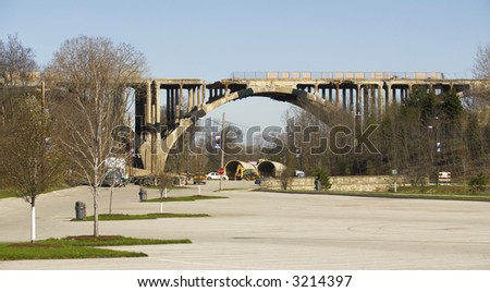 Crumbling arched bridge slated for demolition, wide view