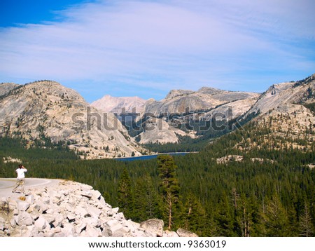 Woman photgraphing Tenaya Lake and High Sierra of Yosemite National Park