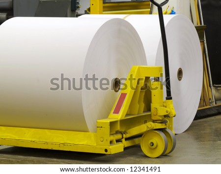 Giant paper rolls waiting to be put on a printing press