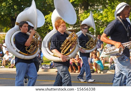 TWINSBURG, OH - AUG 2, 2008: Sousaphone players of the Twinsburg High School Band march past in the annual Twins Days Festival parade in Twinsburg, Ohio.
