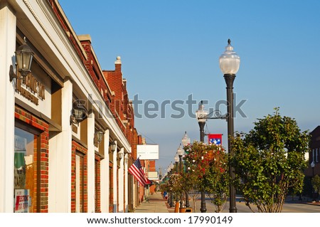 Storefronts, sidewalks, and lamp posts in small-town America