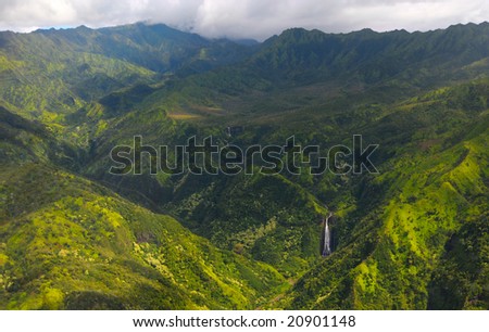 Spectacular aerial view of Manawaiopuna Falls (seen in the movie Jurassic Park) and more distant waterfalls in Kauai\'s green upcountry,