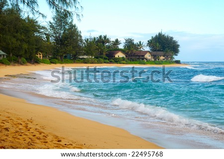 Secluded crescent beach with condos on the north shore of Kauai, Hawaii