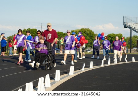 TWINSBURG, OH - June 5: Cancer survivors walk the first lap of Relay for Life, an annual fundraising event sponsored by the American Cancer Society, June 5, 2009, in Twinsburg, Ohio.