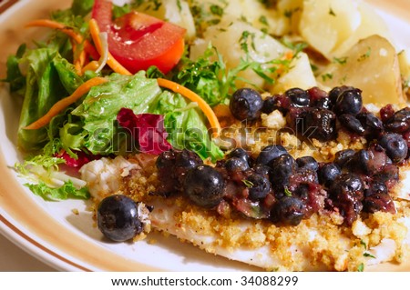 Crouton-crusted tilapia fillets with blueberry pepper sauce, salad and potatoes