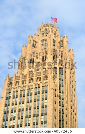 Chicago\'s old Tribune Tower with flag waving in the breeze