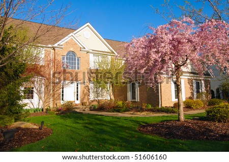 A beautiful home in the early morning light of spring with flowering cherry tree