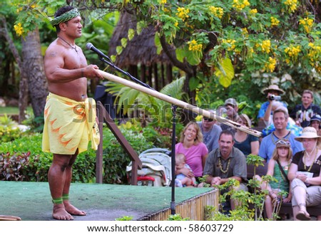 LAIE, HAWAII - OCTOBER 8: An interpretive artist in traditional Samoan garb demonstrates firemaking at the Polynesian Cultural Center in  Laie, Oahu, hawaii on October 8 2008
