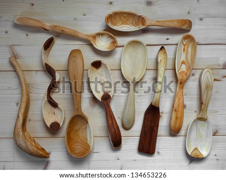hand carved spoons on wooden planks