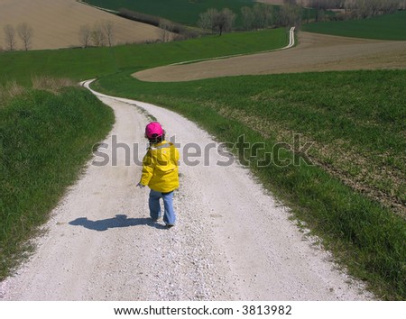 a child walking along a country road
