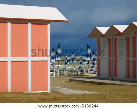 beach huts and umbrellas after a storm