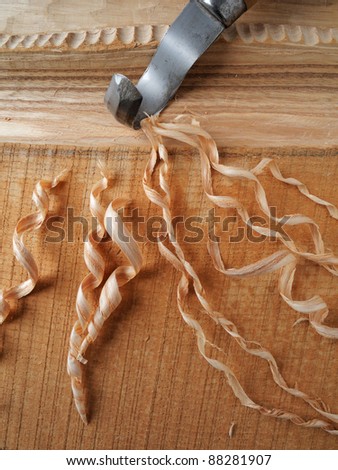 close-up of  hooked knife and wood shavings
