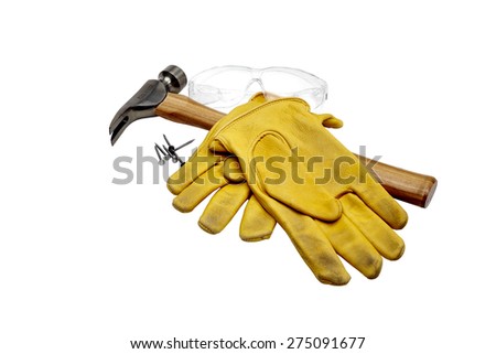 Photograph of a hammer, nails, work gloves and safety goggles isolated on white.