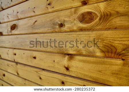 Wall of stained wood pine boards with knots