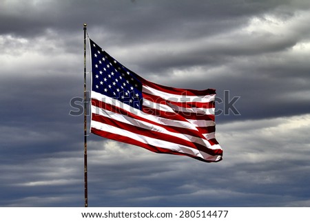 United States of America Flag blowing in the wind against cloudy sky
