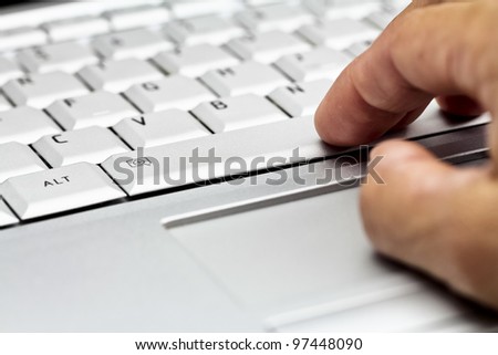 Right hand on laptop keyboard