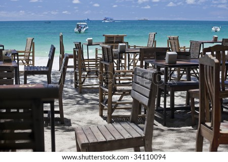 Restaurant tables on a beautiful white sand beach.