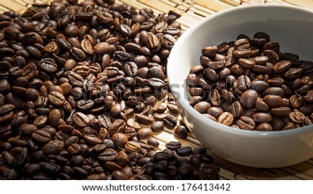Coffee Cup with roasted coffee beans on heap of coffee beans background, Coffee Cup with roasted coffee beans
