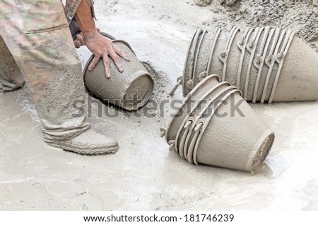 Construction worker mixing cement, Dirty construction work