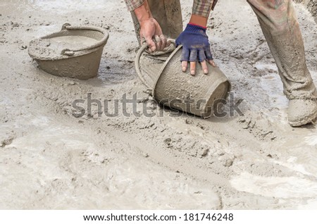 Construction worker mixing cement, Dirty construction work