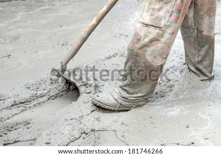 Construction worker mixing cement, Construction worker mixing cement