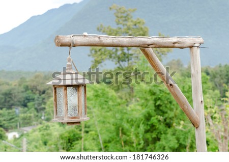 wood lanterns hanging in the front yard , wood lamp hang on Branch