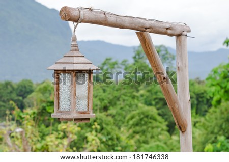 wood lanterns hanging in the front yard , wood lamp hang on Branch