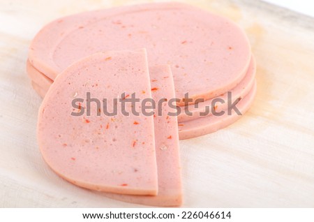 Bologna sausage thin sliced cut with knife