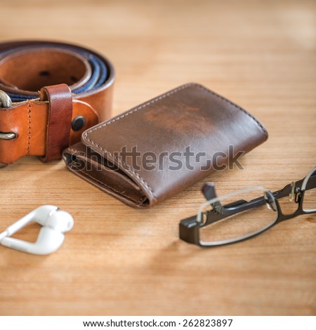 still life with brown wallet on wooden background, selective focus on wallet